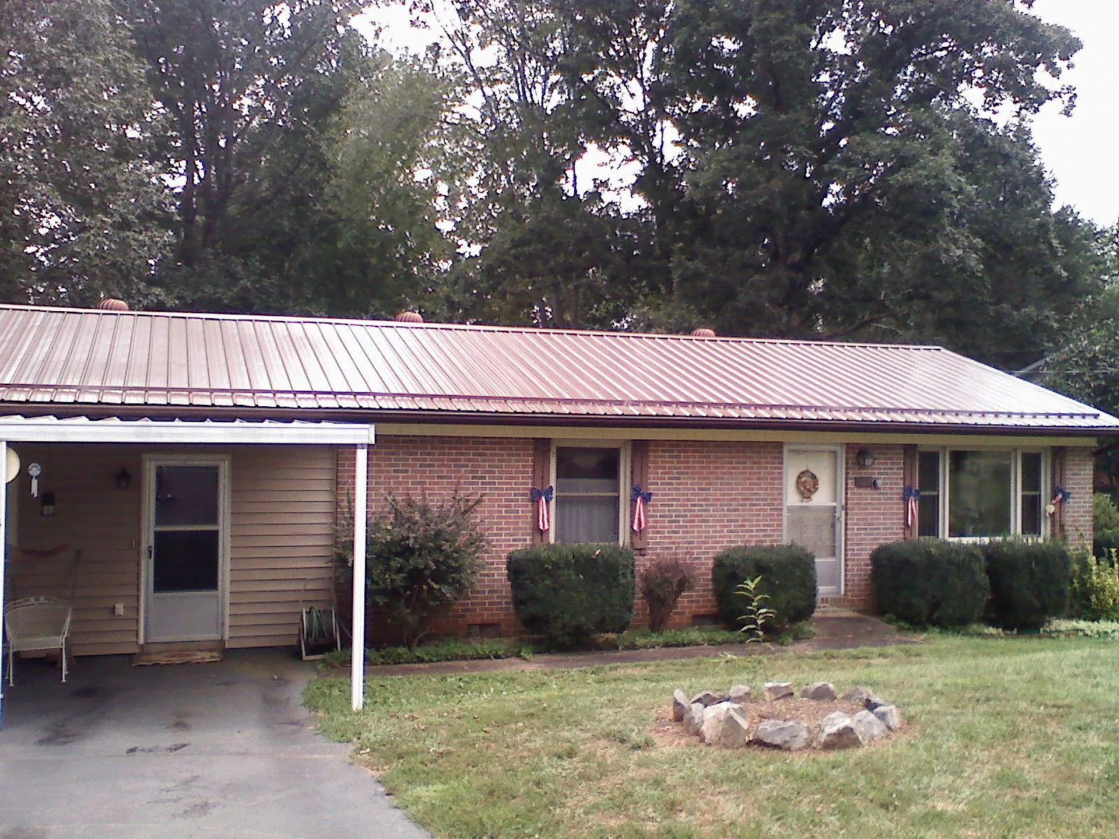 Bronze metal roof and carport on a brick ranch home — Roof Repair work by our crew in Alviso